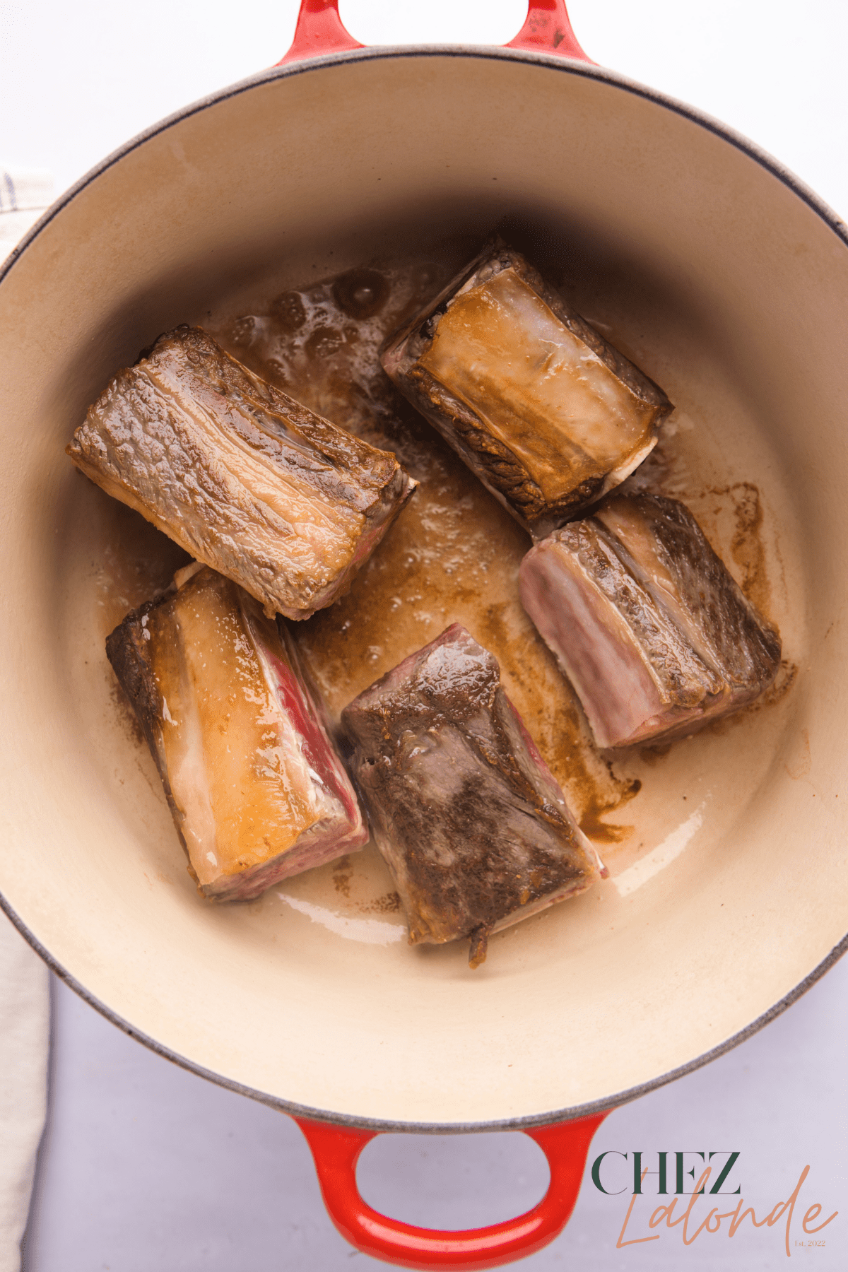 Sear short ribs in a dutch oven until golden brown.