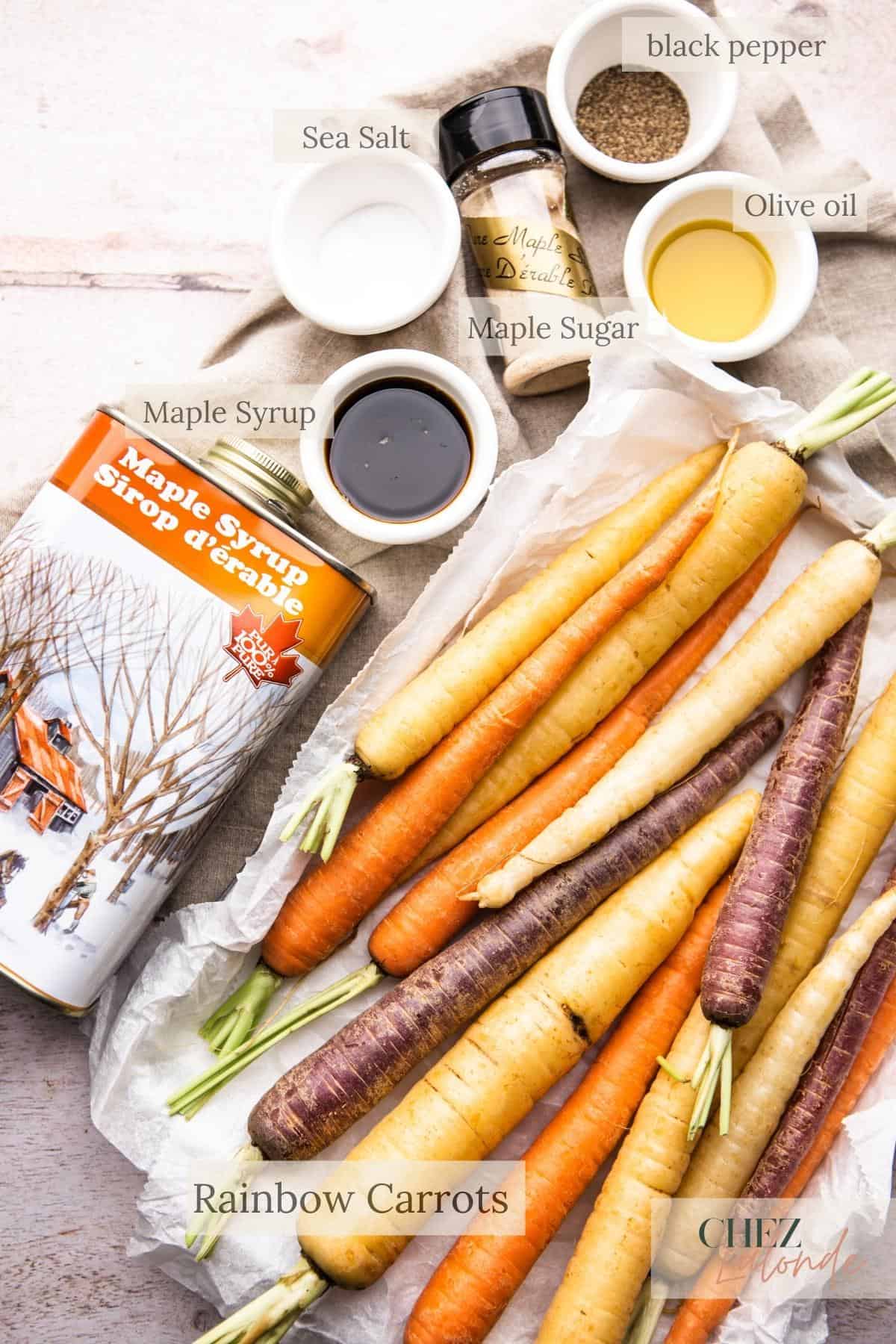 A list of ingredients for making Maple roasted rainbow carrots. There are maple syrup, salt and pepper, maple sugar, olive oil, and about 2 lbs of rainbow carrots. 