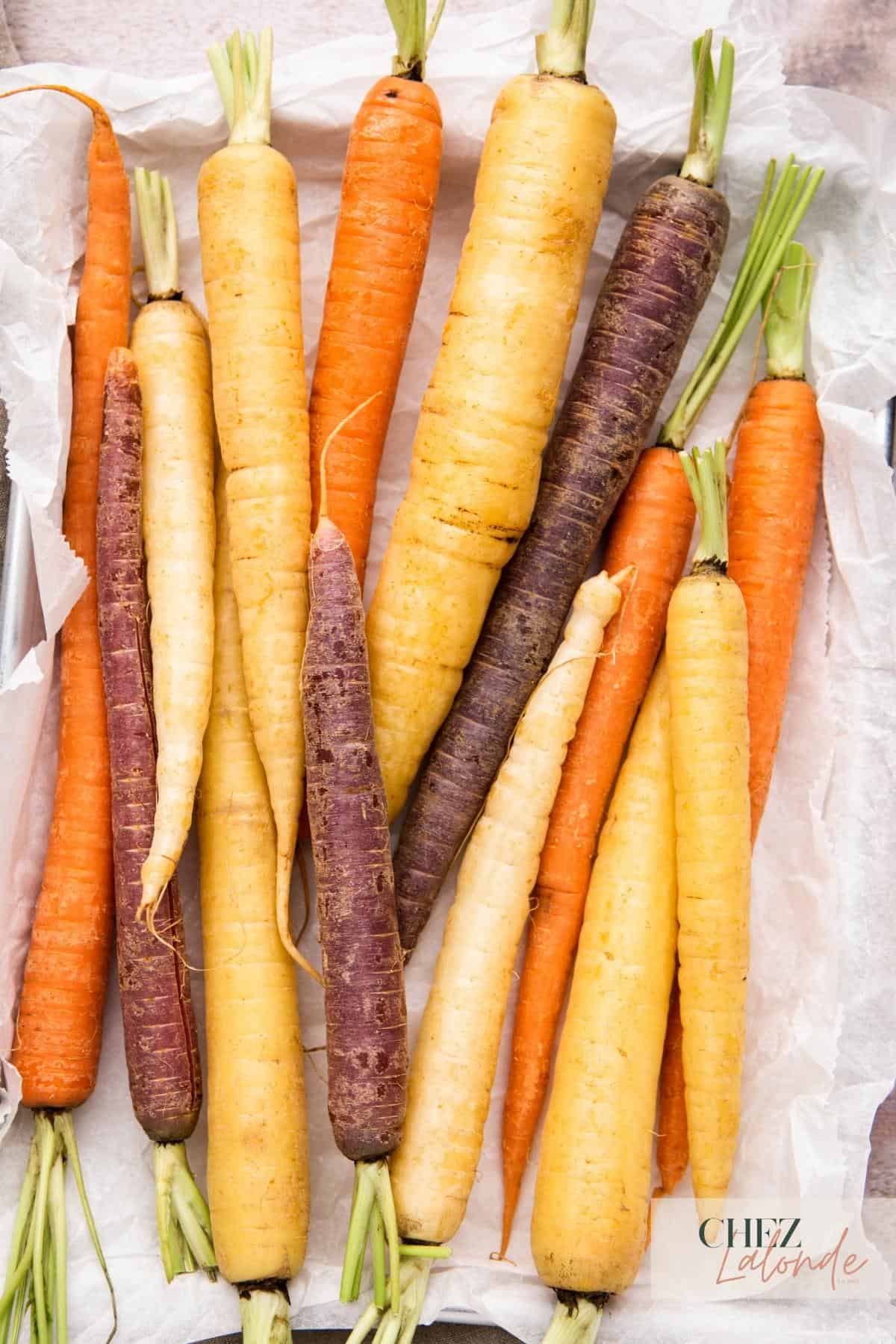 a tray of uncooked rainbow carrots.