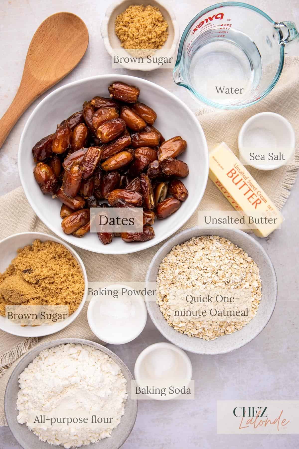 A table topped with bowls filled with different types of ingredients for making date squares.