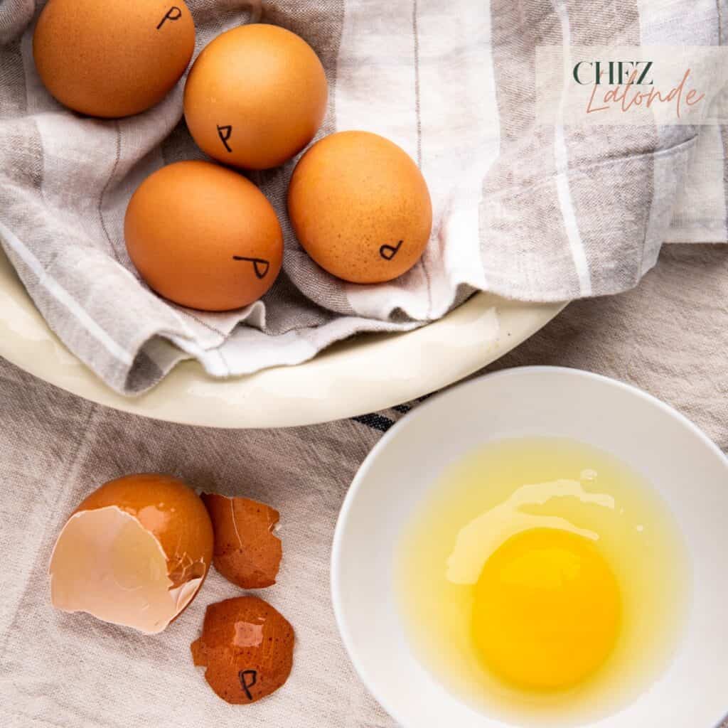 Pasteurize eggs in a white bowl and a cracked pasteurized eggs.
