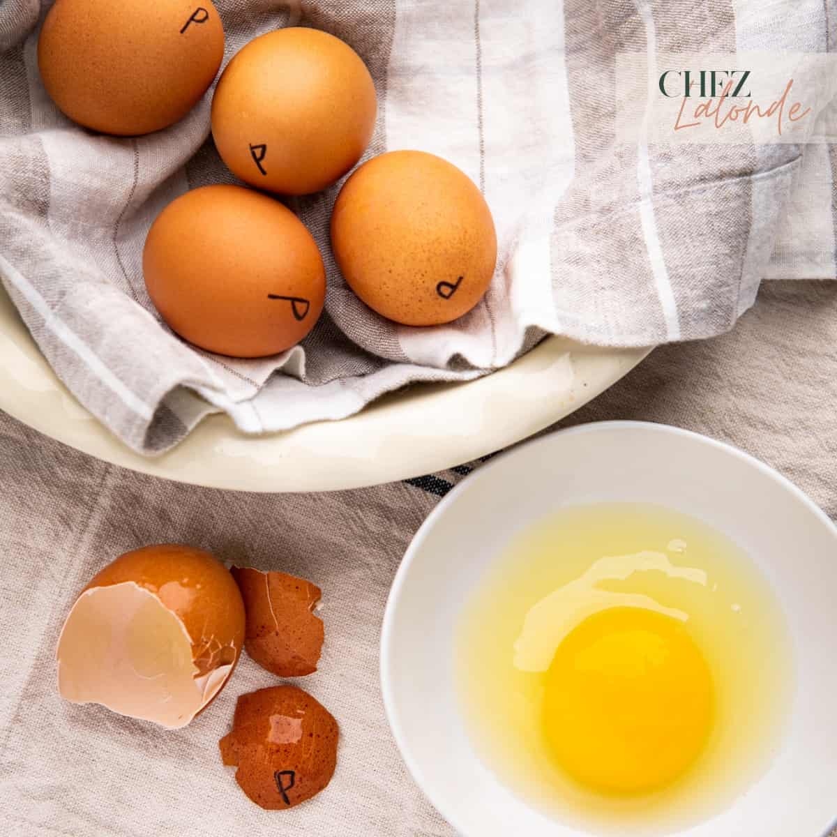 Pasteurize eggs in a white bowl and a cracked pasteurized eggs.
