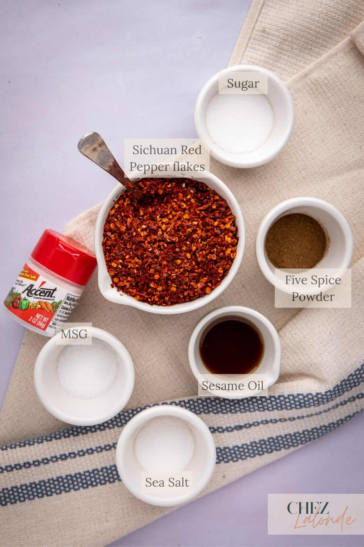 Group 2 ingredients needed for making Homemade chinese Chili Oil. You will need sichuan red pepper flakes, sugar, sea salt, toasted sesame oil, five spice powder, and MSG.