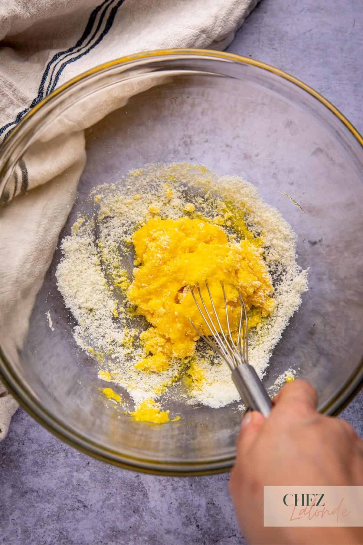 Mixing egg yolk and cheese paste for carbonara paste.