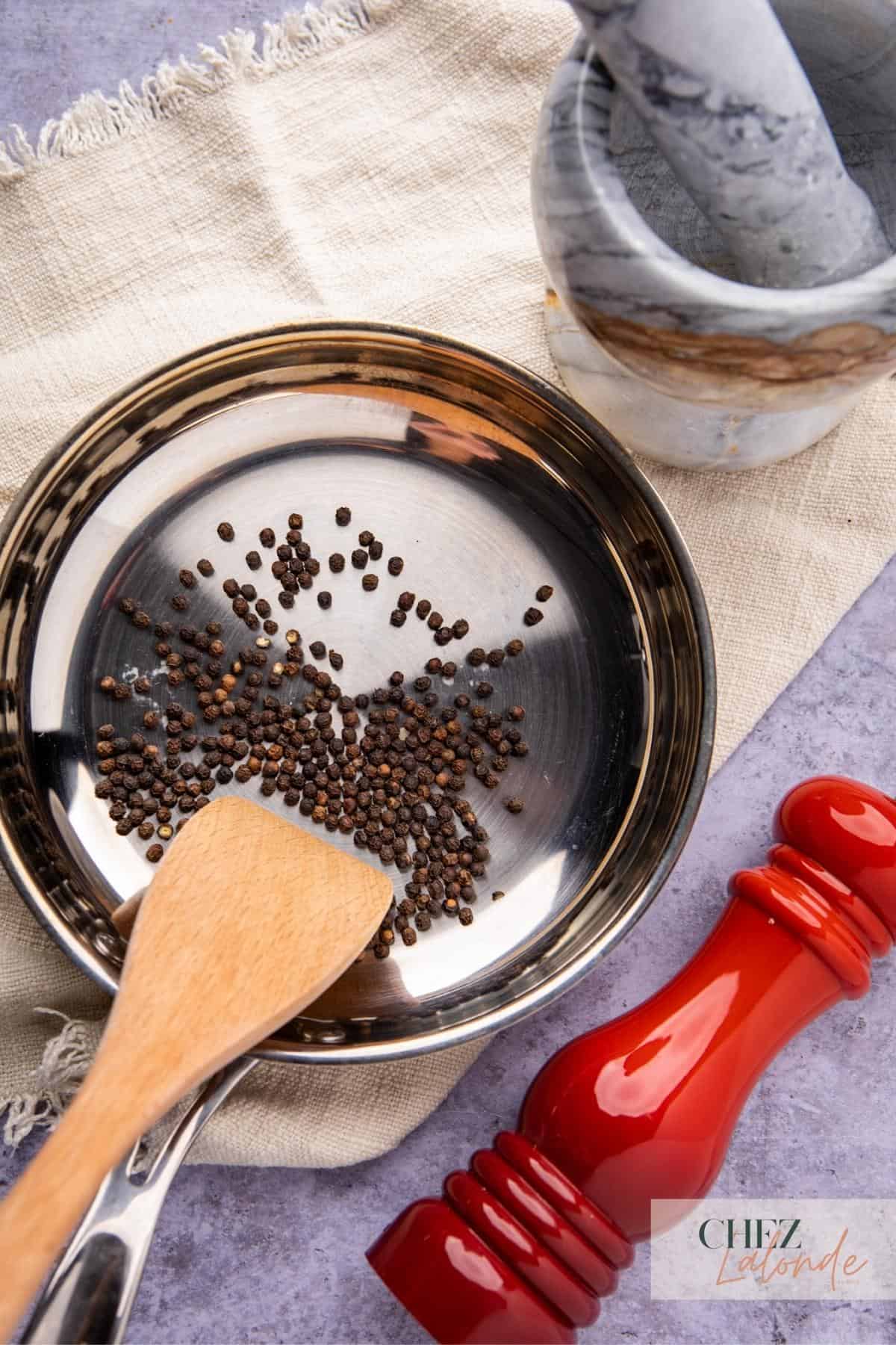Toasting black peppercorn in a small frying pan