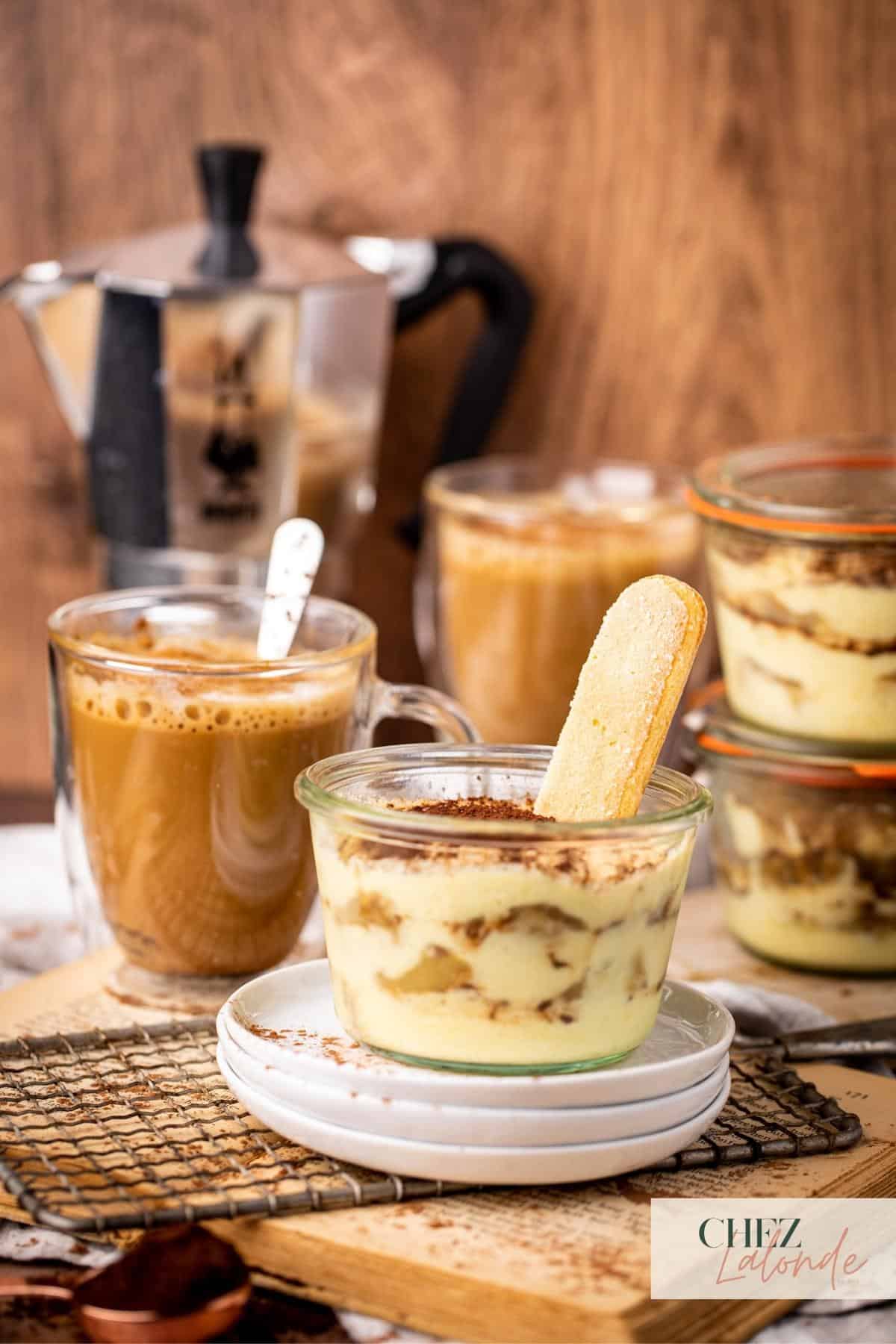 A jar of Tiramisu with a cup of freshly brewed Moka coffee with cream. 