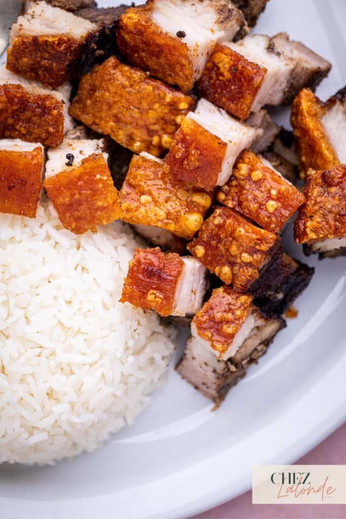 Closed up photos of a plate of Cantonese style Air fryer pork belly served with steamed rice.
