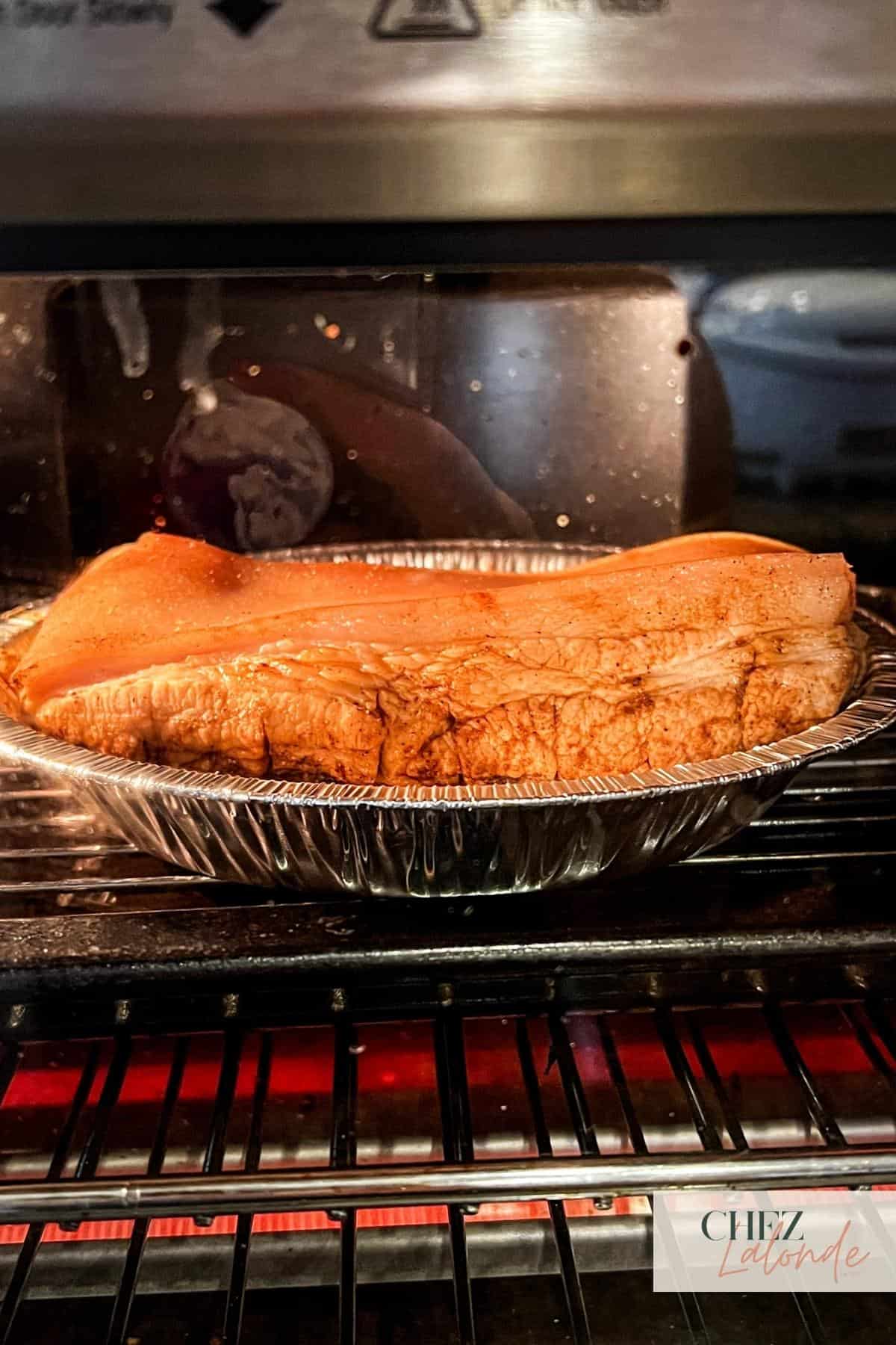 Pork belly being cooked inside the toaster oven.