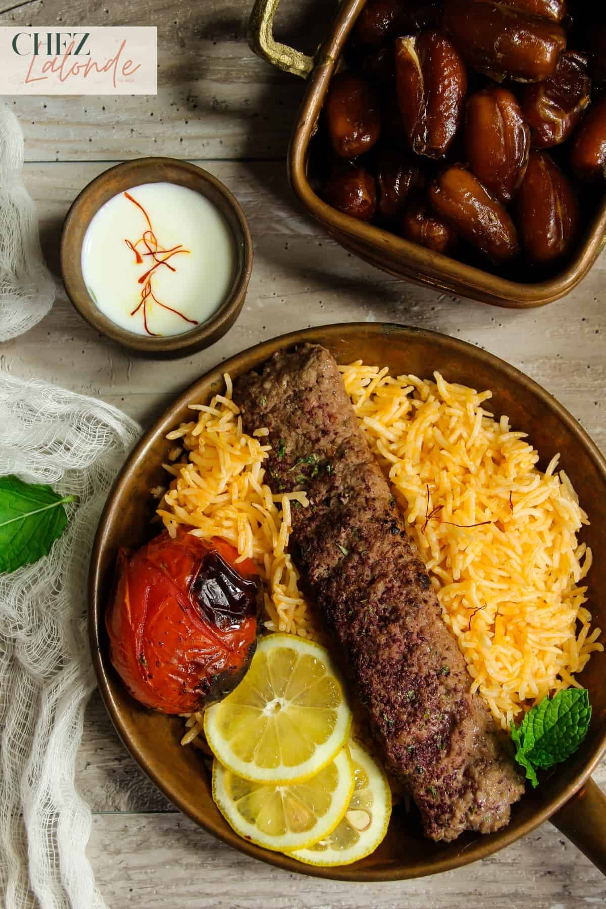 A bowl of saffron rice with Kebab and other vegetables. 