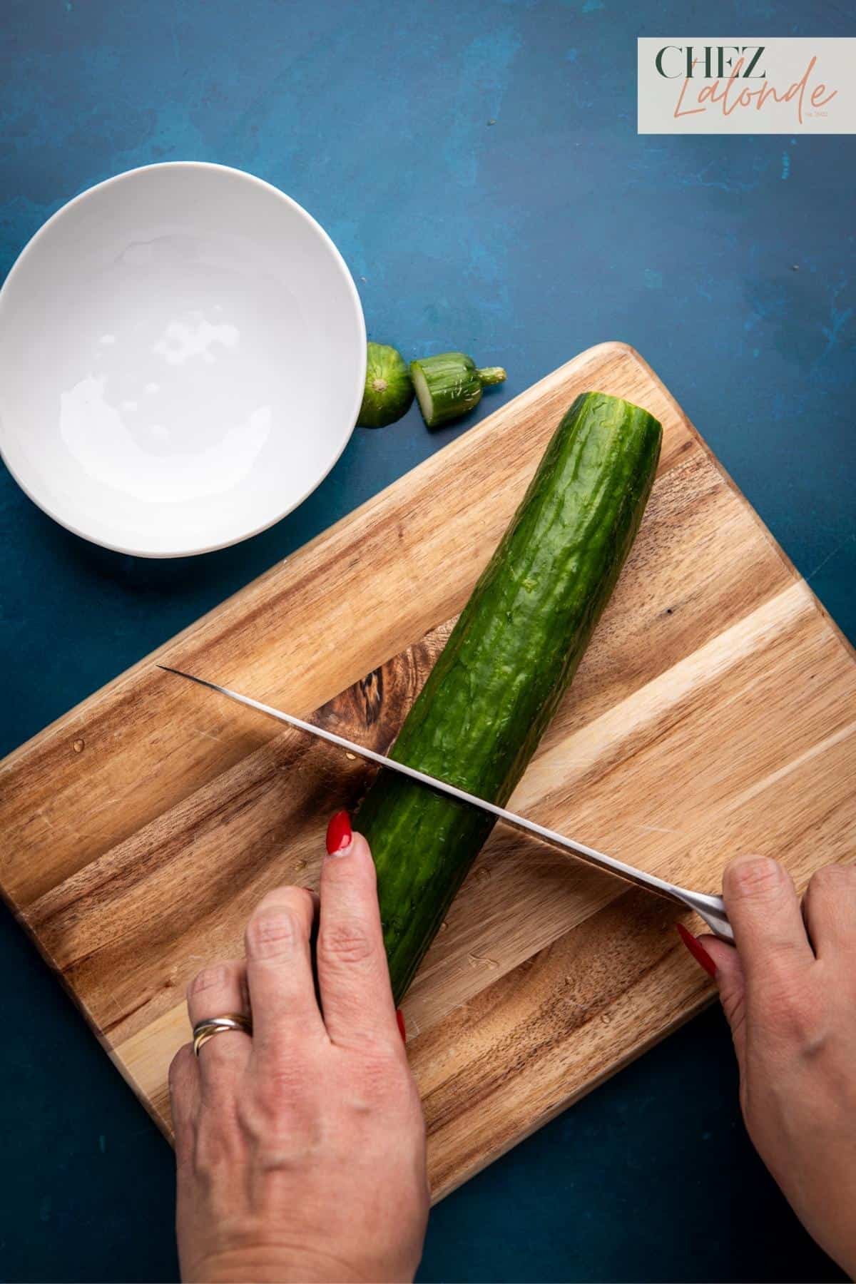 Cutting an English cucumber in half.