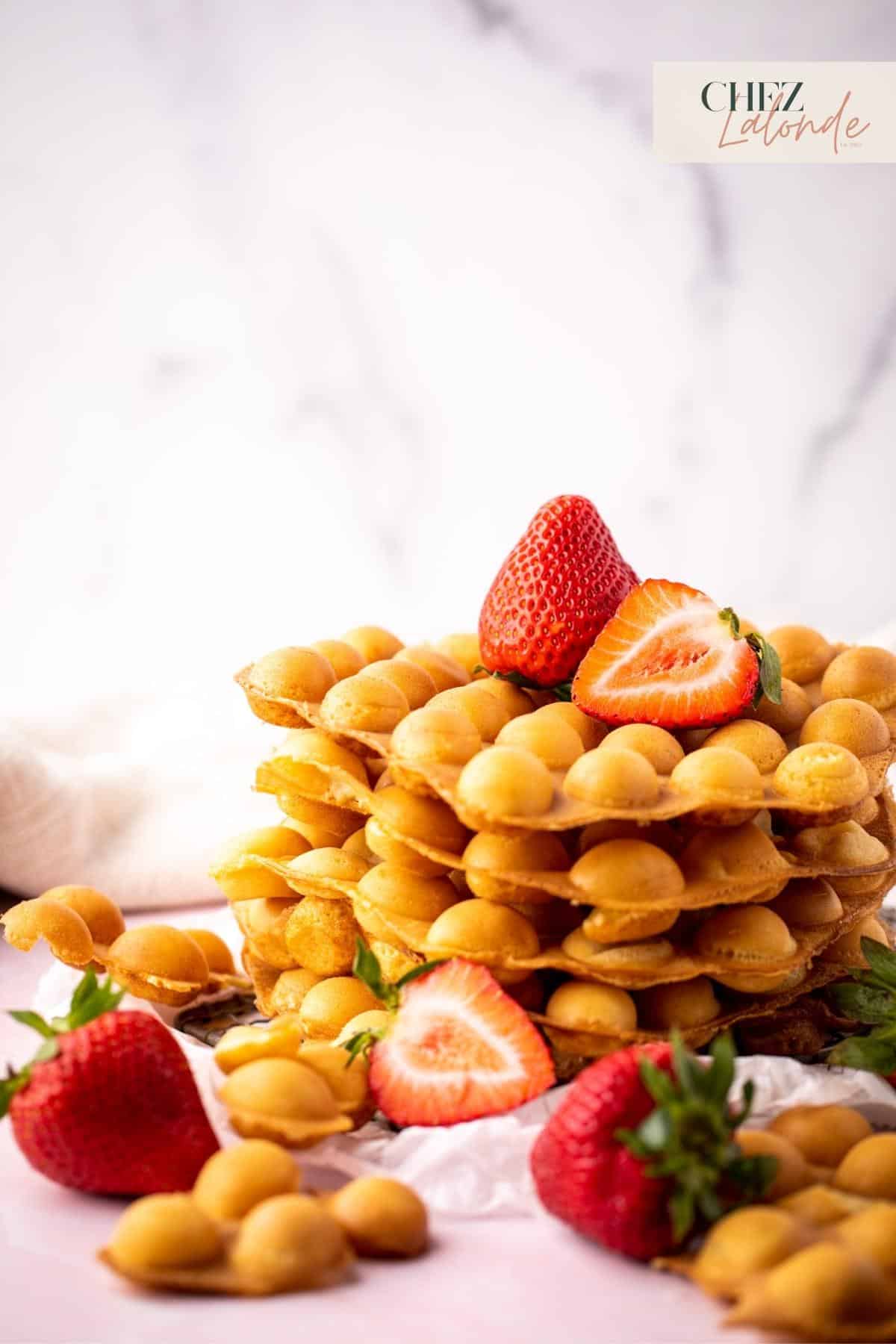 A stack of Hong Kong Bubble waffles with strawberries. 