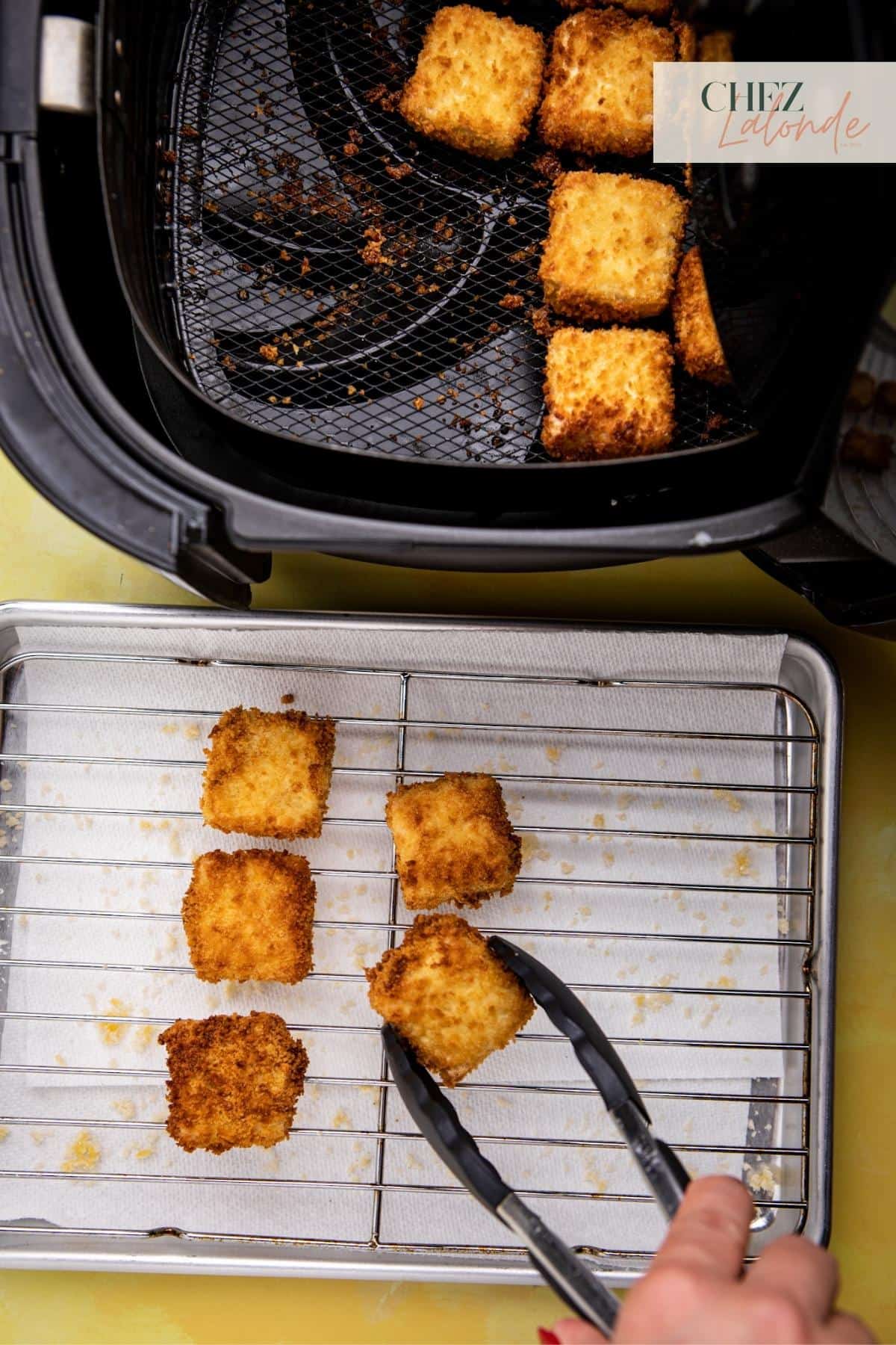 Use a tongs to transfer cooked tofu to wire rack.