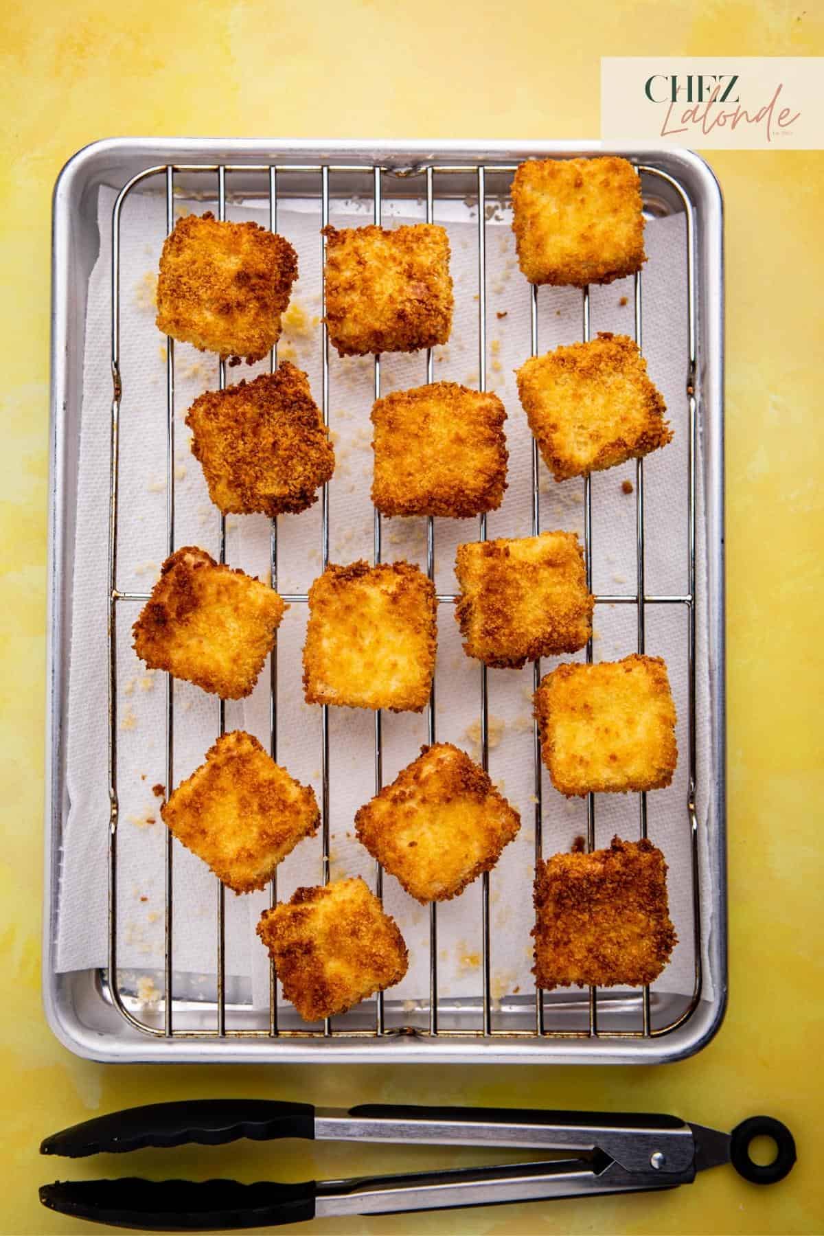 Letting air fried tofu to rest on wire rack for a few minutes to allow the outer layer to become crispy and firm up.