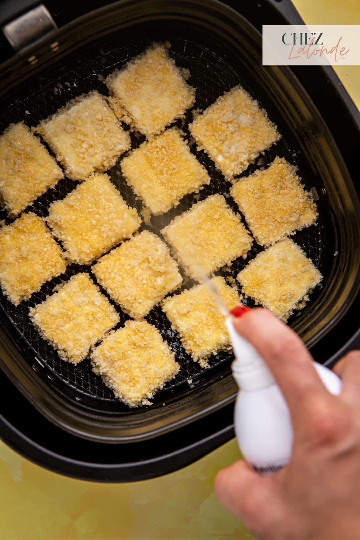 After placing tofu inside the air frying basket. Spray a thin coat of cooking spray to prevent it from sticking.