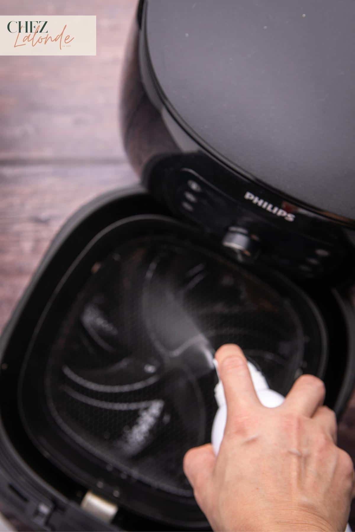 Using a cooking spray to spray the air fryer basket to prevent sticking.