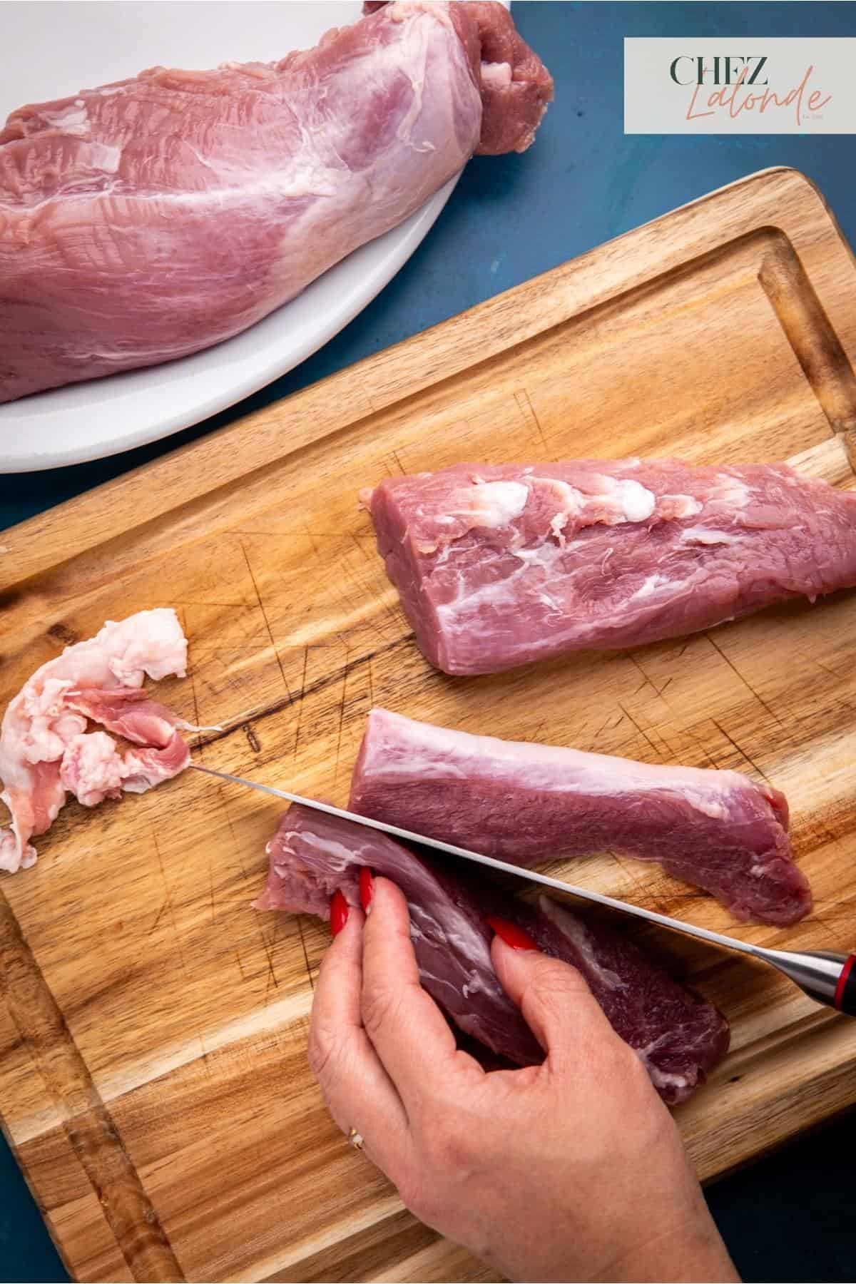 Slicing the pork tenderloin in half.
