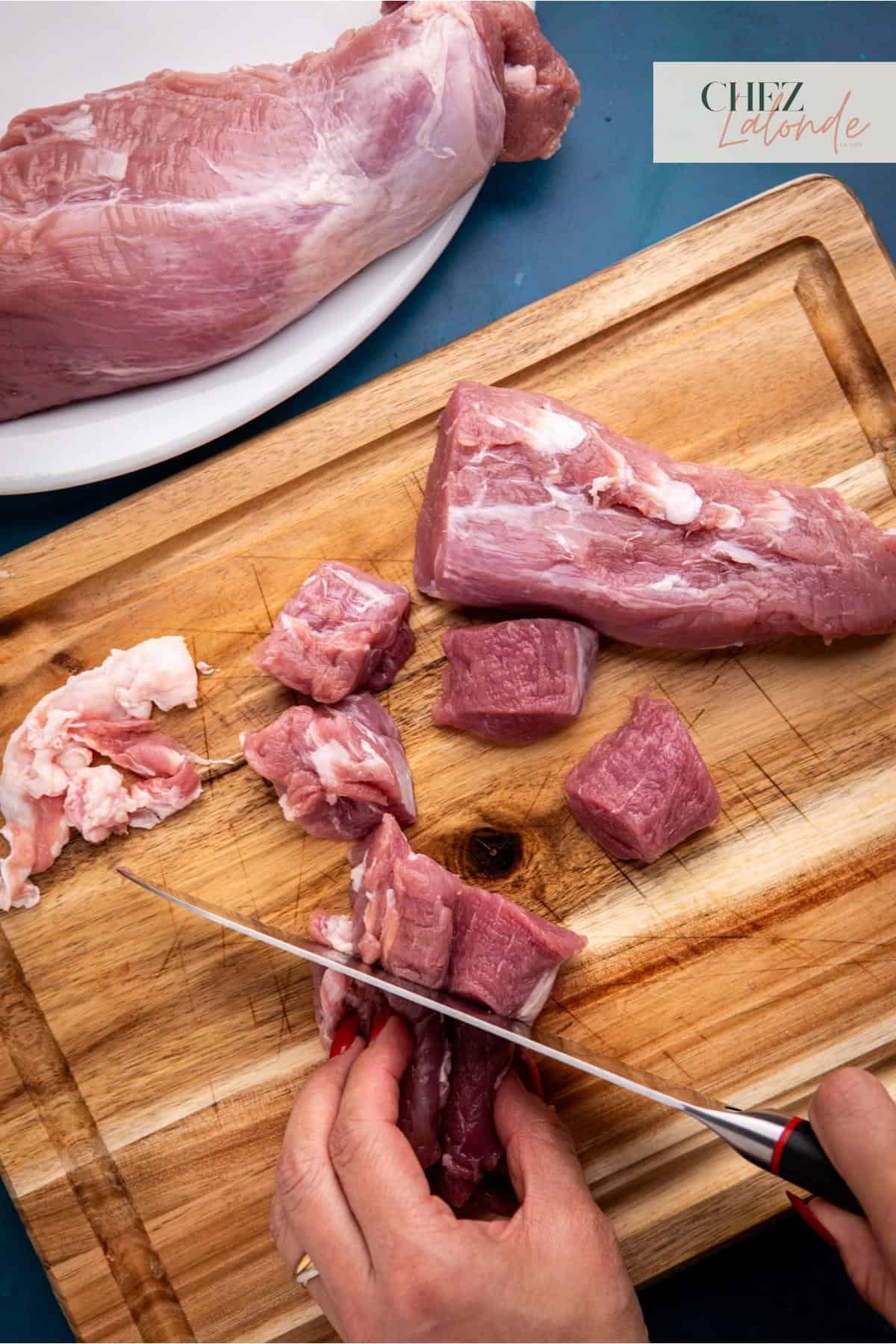 cutting the pork tenderloin in a 1.5 by 1.5 inch cubes.