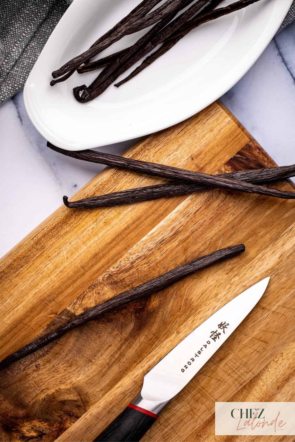 Vanilla Beans on cutting board with paring knife. 