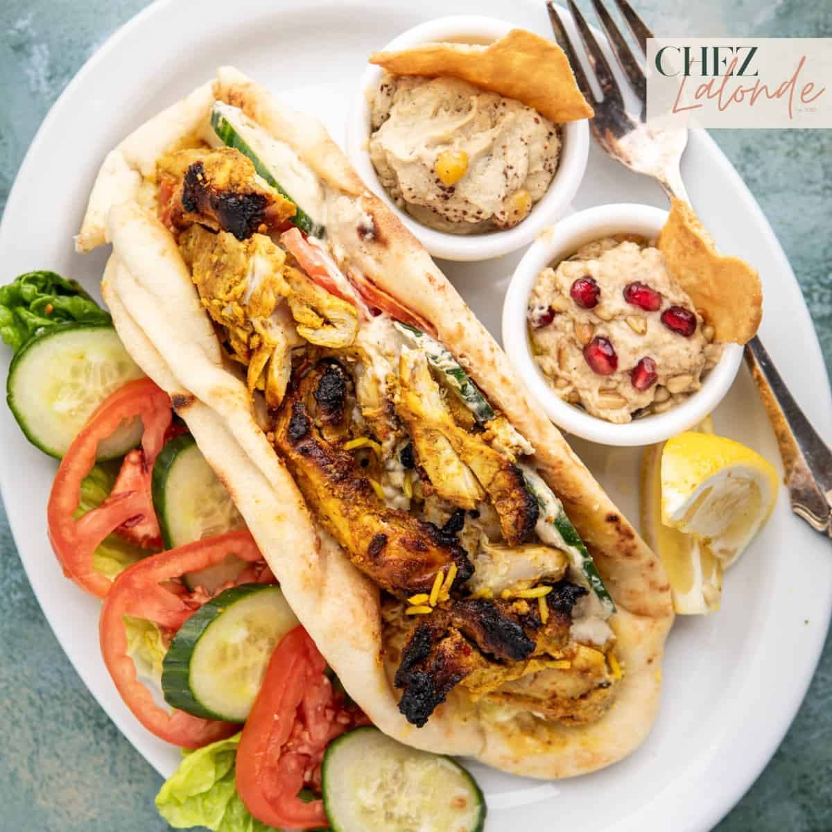 Air fryer chicken shawarma wrapped in Naan bread. Served with fresh vegetables, lemon wedges, hummus, and Baba ganoush.