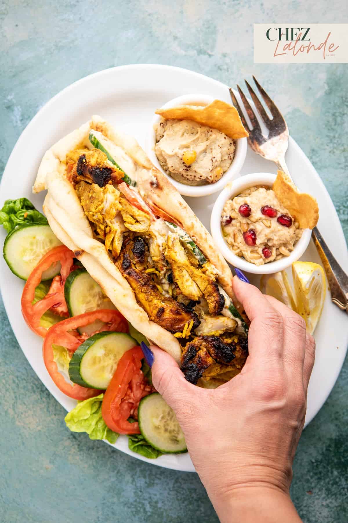 Air Fryer Chicken Shawarma served with a side of hummus, baba ganoush, and salad.