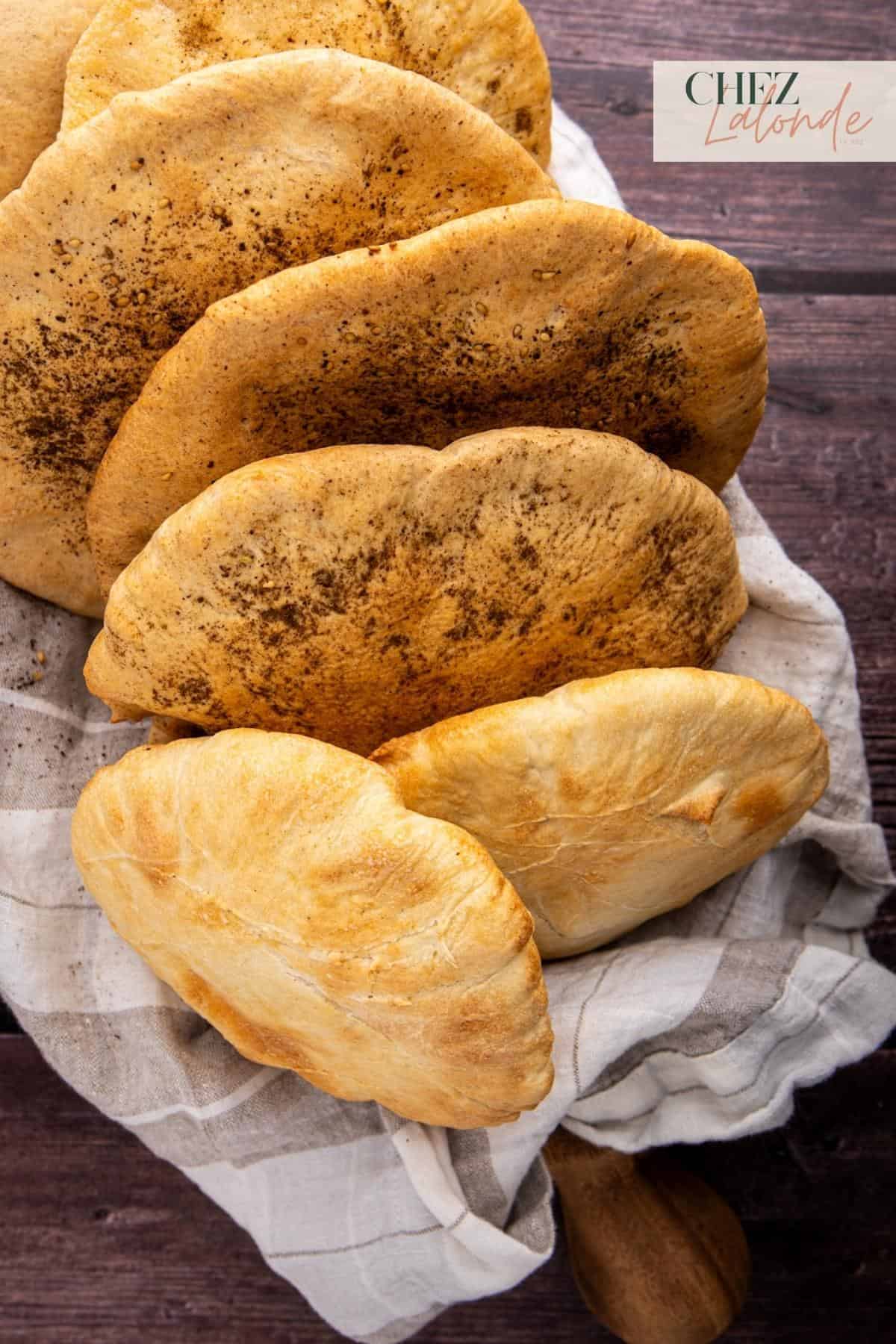 A basket full of pita bread that were cooked in an air fryer. 