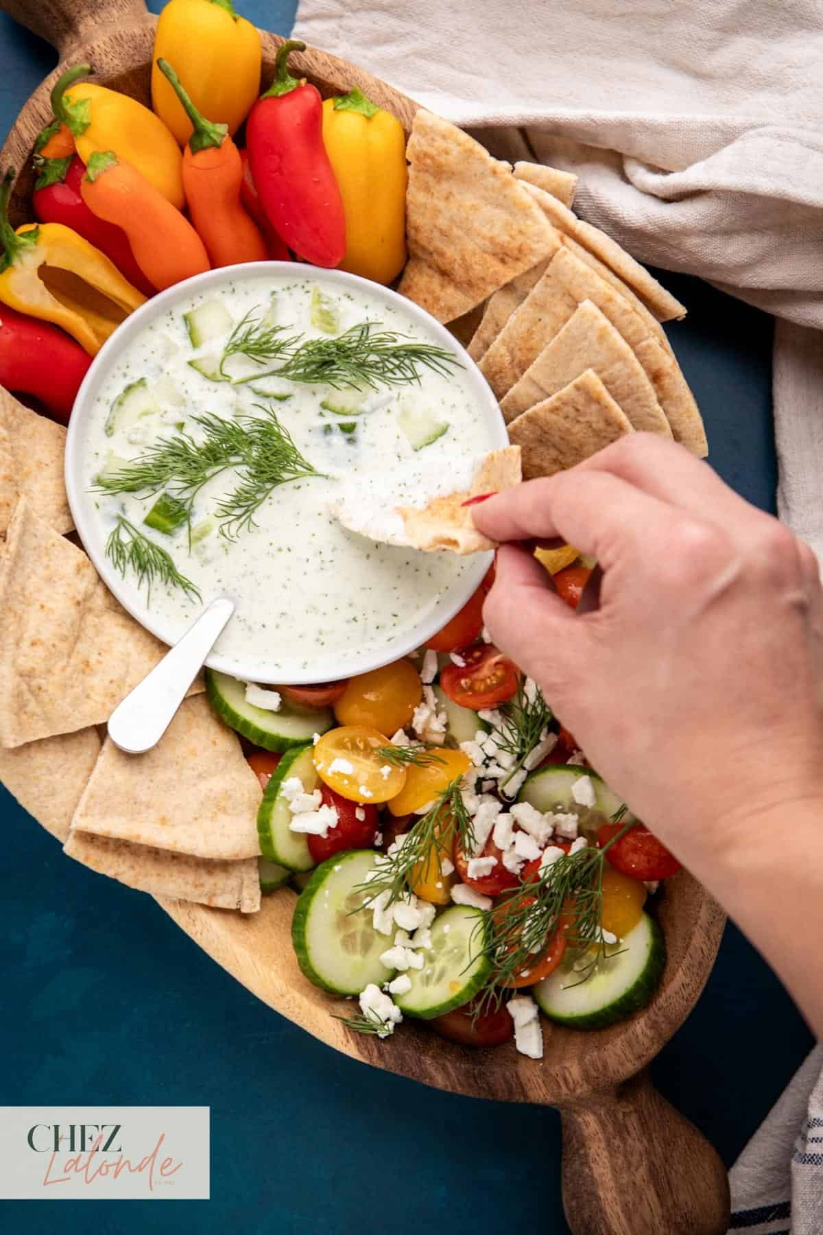 Garlicky Greek Yogurt and Cucumber Sauce (Tzatziki) with pita bread and vegetable. 