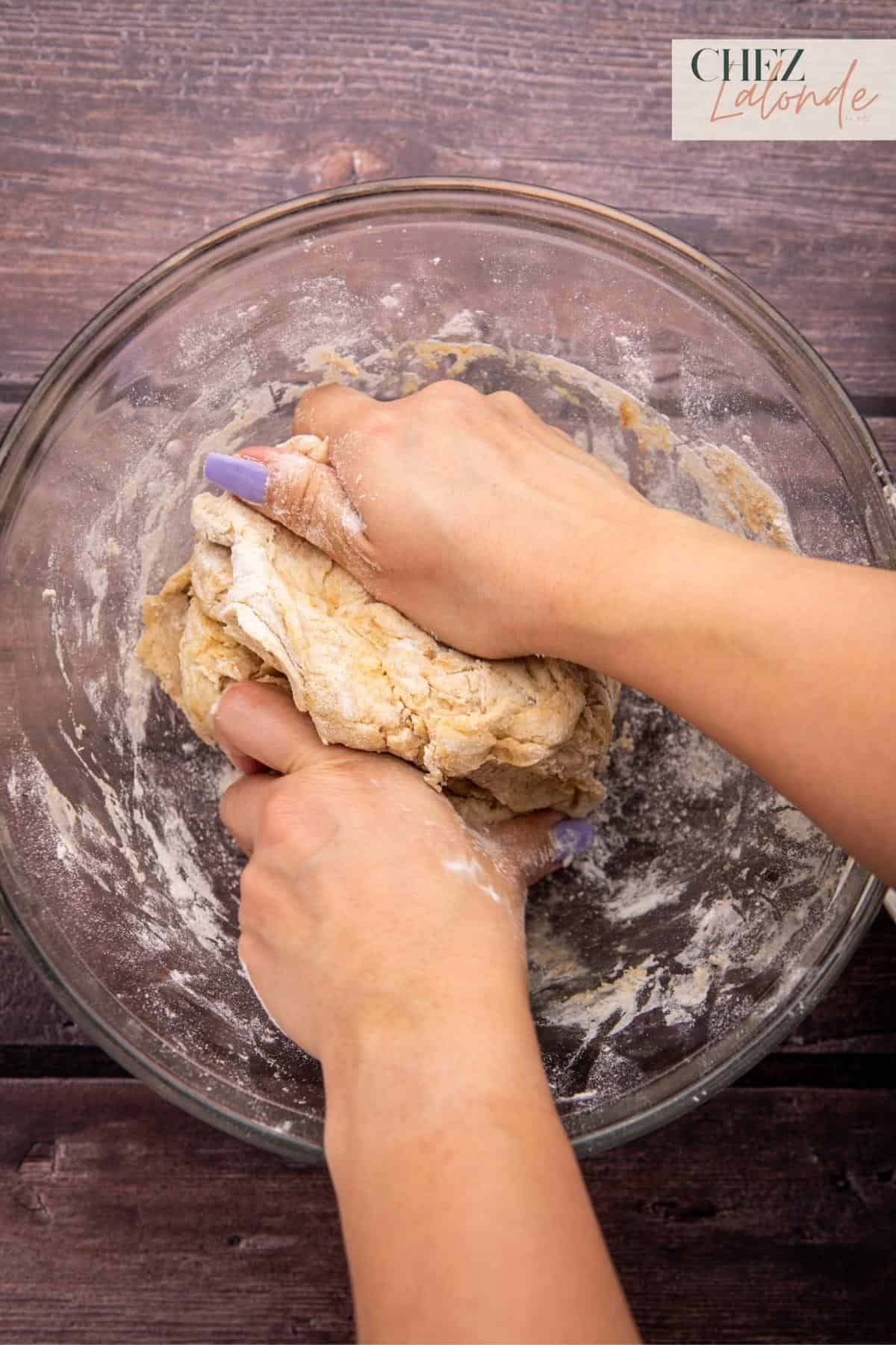 After incorporating the mixture, continue kneading the dough by hand for a minute or two until the texture becomes less tacky.
