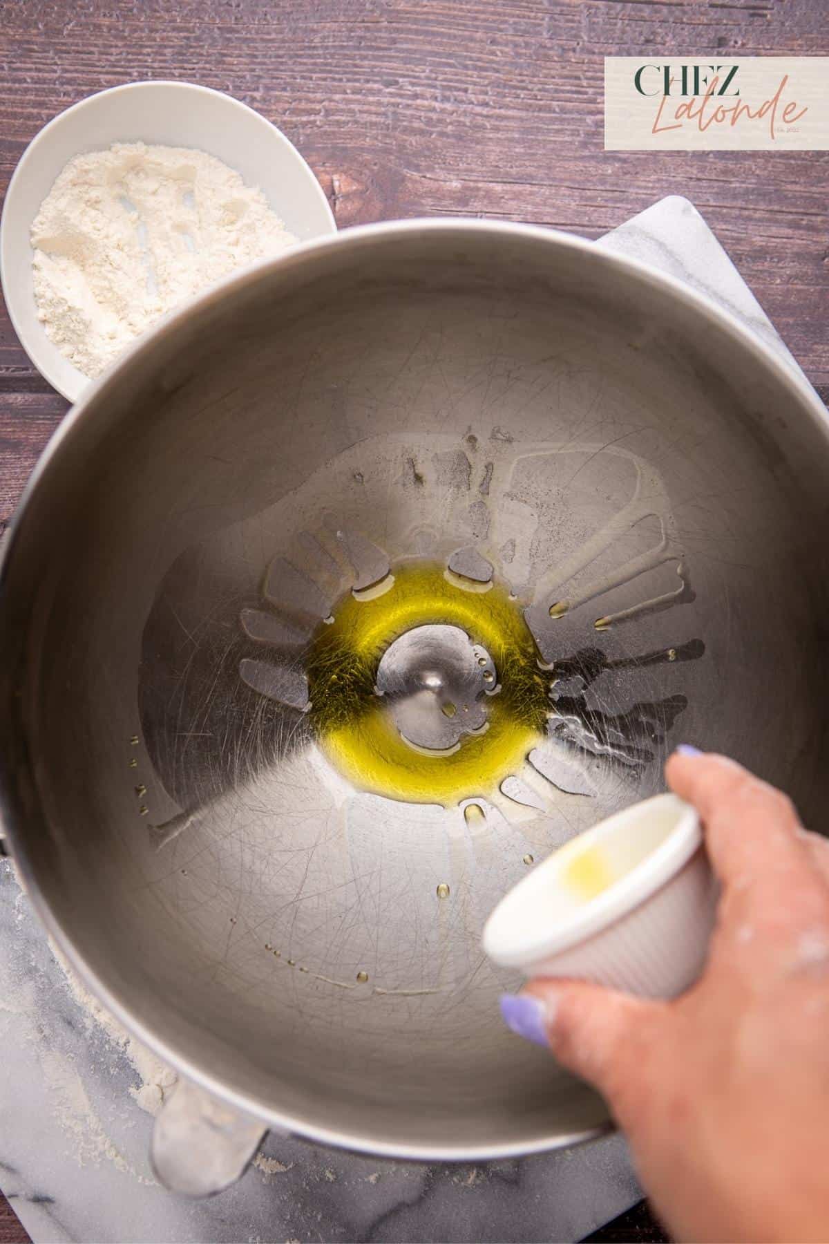 Drizzle a tablespoon of olive oil in the stand mixing bowl and spread it around to prevent sticking.