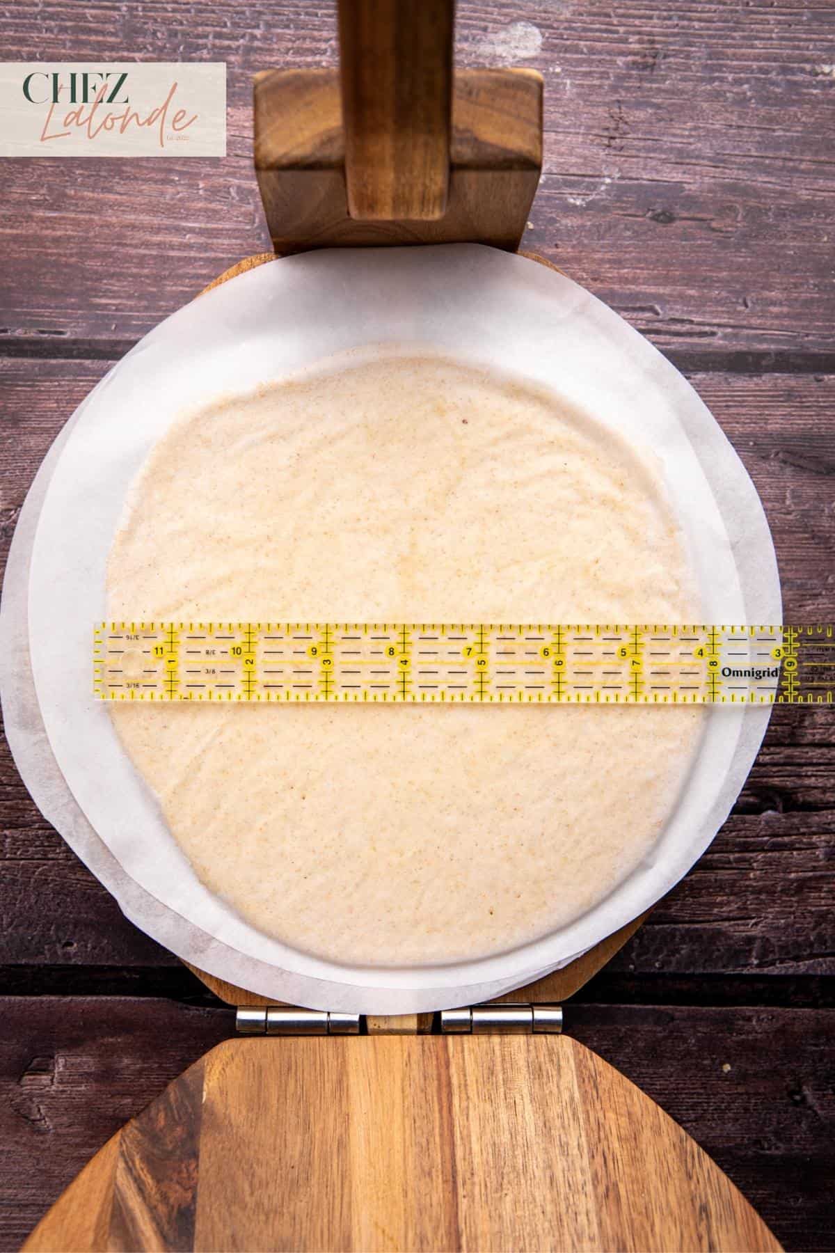Using a ruler to make sure the size is right.  Here in the picture this pita is measured at 8 inches in diameter. 