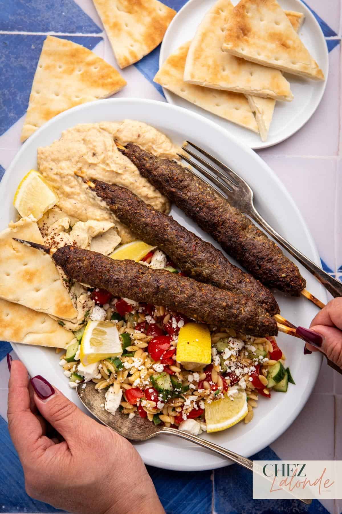 I was having a Mediterranean platter with 3 skewers of air fryer Kofta Kebabs, served with Orzo and cucumber salad , pita bread, baba ganoush, and Hummus.