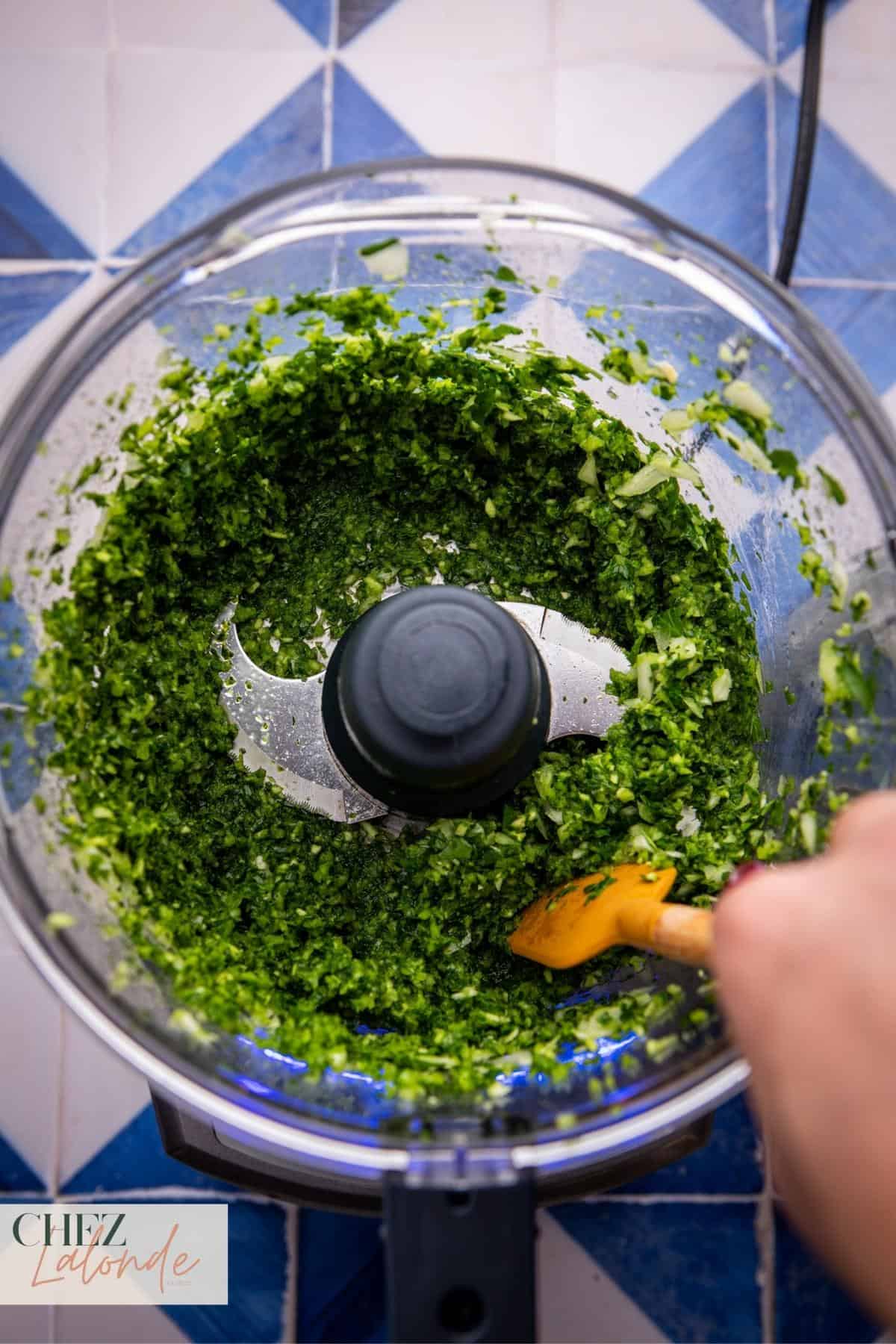 Give it a few pulses, occasionally scraping down the sides, until the herbs transform into a finely textured paste.