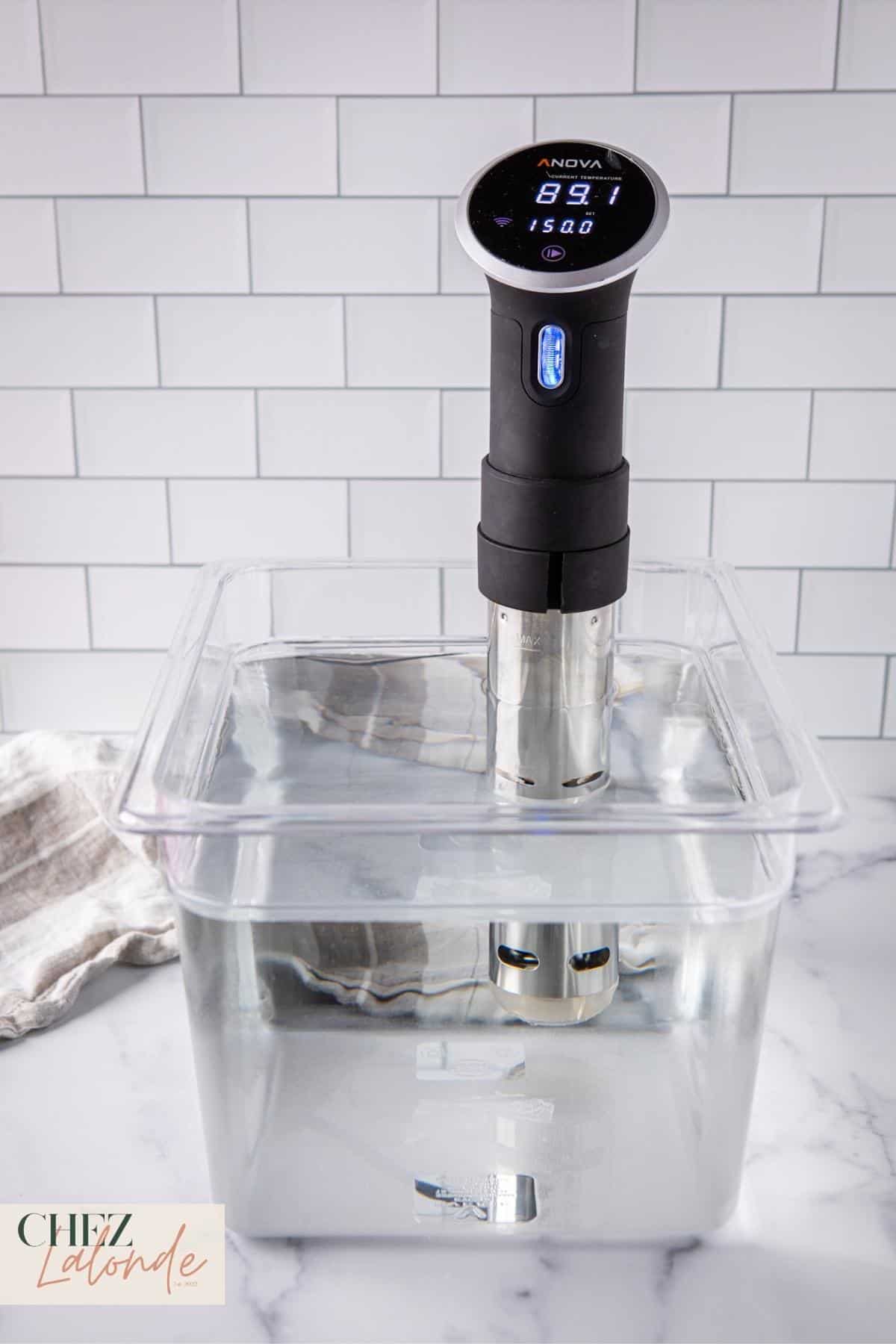 This is Sous Vide cooking. A clear container attached with a Sous Vide precision cooker.